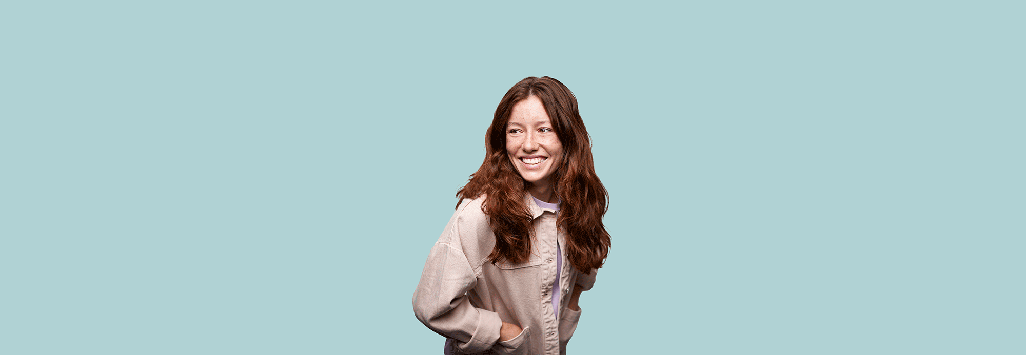 A woman wearing a pink denim jacket