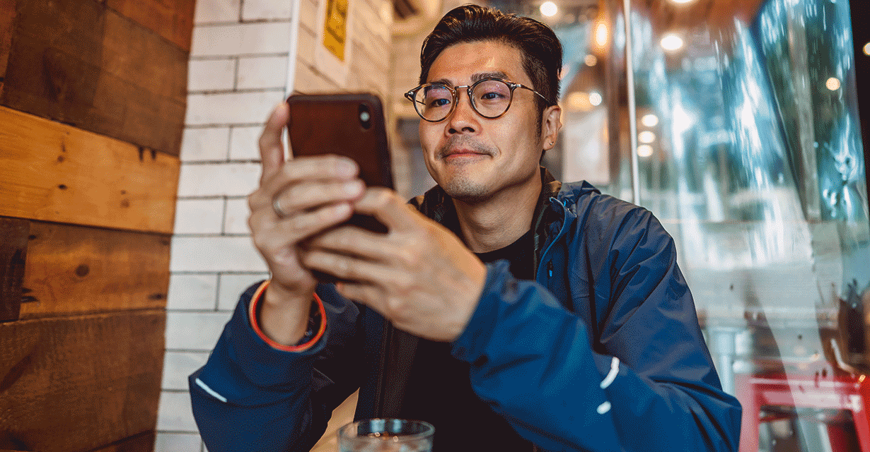A man at a cafe texting